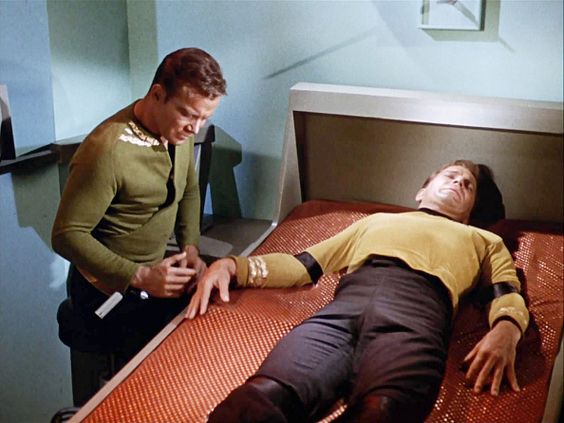 LOS ANGELES - OCTOBER 6: William Shatner, as split versions of Captain James T. Kirk in STAR TREK: THE ORIGINAL SERIES episode, "The Enemy Within." Season 1, episode 5. He is seen here as the good self, (approaching at left), and the evil version (lying down, in sick bay). Original air date is October 6, 1966. Image is a screen grab. (Photo by CBS via Getty Images) *** Local Caption *** William Shatner
